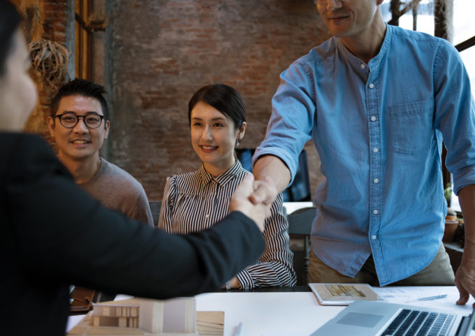 handshake across table