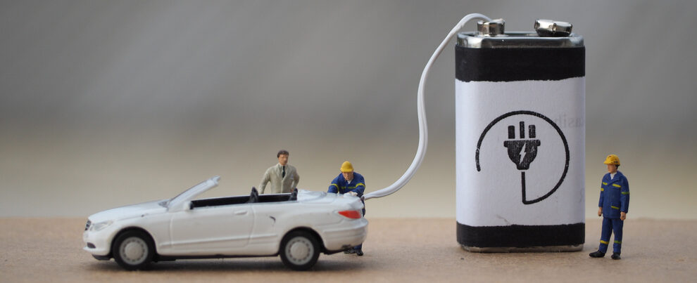 miniature car being recharged by a large battery