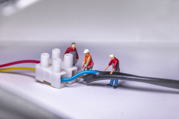 men connecting electric cables